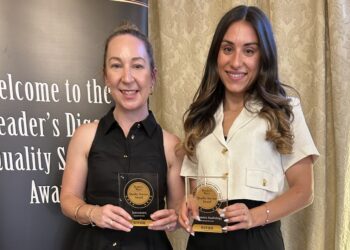 Michaela Cassidy (left), Specsavers head of customer operations, and Maree Patikas, audiology partner, Roseland, Bankstown and Chullora, with the company's Reader's Digest awards. Image: Reader's Digest.