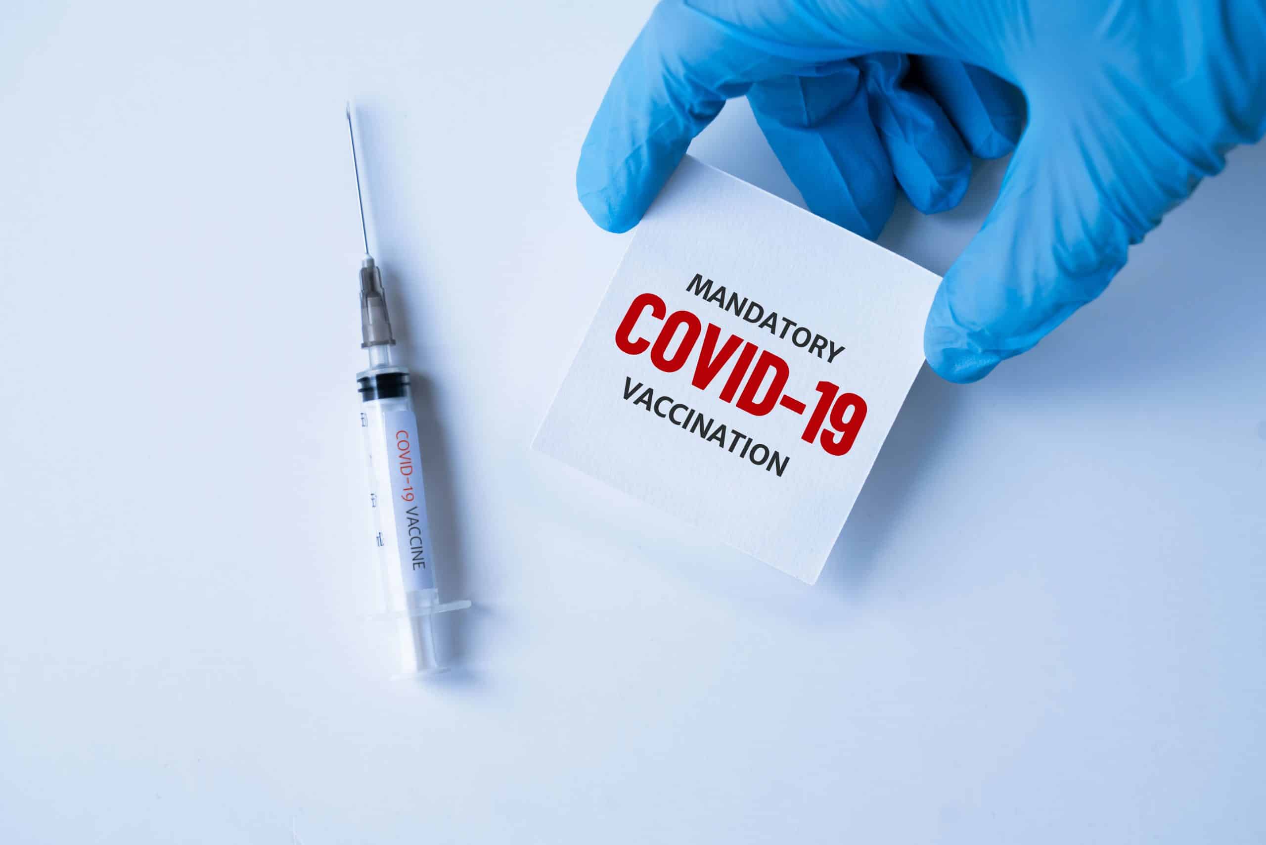 mandatory covid-19 vaccination. medicine, healthcare and pandemic concept. medical mask, syringe vaccine mutation, mutated new strain of coronavirus SARS-CoV-2 VUI â€“ 202012-01. Covid-2020