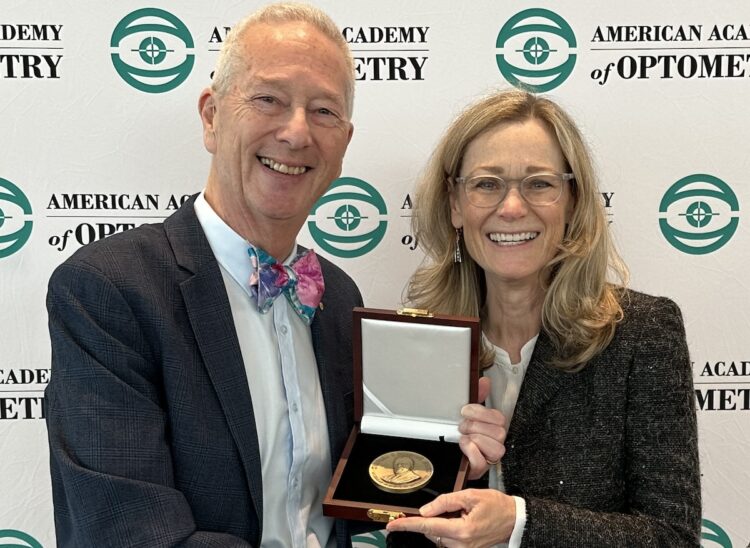Professor Nathan Efron is presented with his award by American Academy of Optometry president Dr Sue Cotter. Image: American Academy of Optometry.