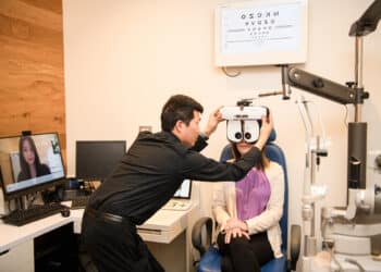 OPSM’s remote optometry journey, with the optometrist on screen and the in-person aspect by a technician. Image: EssilorLuxottica.