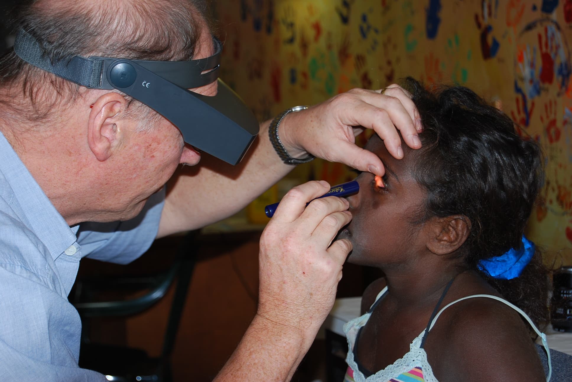 Prof Hugh Taylor examining young Aboriginal and Torres Strait Islander patient. Image: University of Melbourne.